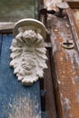 Little wooden door guarded by giant