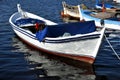 Little wooden fishing boats, moored and floating on a beautiful blue sea in Turkey. Royalty Free Stock Photo