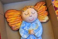 Little wooden painted angel figure sleeping in box Royalty Free Stock Photo