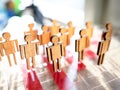 Little wooden toy people figures stand in row Royalty Free Stock Photo