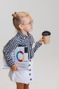 Cropped side view portrait of cute little girl in casual clothing and stylish glasses isolated over gray background Royalty Free Stock Photo