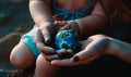 Little world globe holding in baby`s hand. Small planet in kids hands. Generative AI