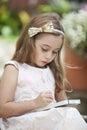 Little writer with her notebook and pencil