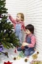 Little 5 years brother and 1 year sister in red plaid shirts and