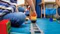 Little 4 years old boy sitting on carpet and playing with toy trains Royalty Free Stock Photo