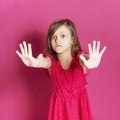 Little 8 years old girl make some emotional gesture with her han Royalty Free Stock Photo