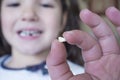 Little 5 years old girl showing her first baby tooth fallen out