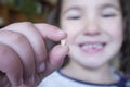 Little 5 years old girl showing her first baby tooth fallen out