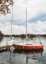 Little yellow sport yacht on the lake Trakai, Lithuania. Beautiful summer landscape of Trakai lake in the stormy evening with