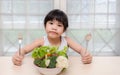 Little young cute sweet smiling girl eats fresh salad / healthy eating concept Royalty Free Stock Photo