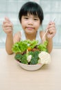 Little young cute sweet smiling girl eats fresh salad / healthy eating concept Royalty Free Stock Photo