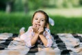 Little young girl lying on the grass in the park, dreaming of something Royalty Free Stock Photo