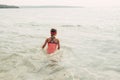 Little young girl swimming in lake river with underwater goggles. Child diving in water on a beach. Authentic real lifestyle happy Royalty Free Stock Photo