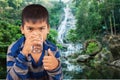 Littleboy drinking water on nature background