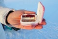 Live bloodworm in a box container. Red worms for winter fishing. A woman holds a box of bloodworms in her hands and Royalty Free Stock Photo