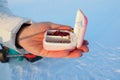 Live bloodworm in a box container. Red worms for winter fishing. A woman holds a box of bloodworms in her hands and Royalty Free Stock Photo