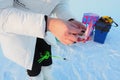 Live bloodworm in a box container. Red worms for winter fishing. A woman holds a box of bloodworms in her hands and Royalty Free Stock Photo