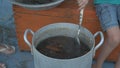 Live crayfish caught in river are cooked in arge aluminum pan in open air. Woman puts dill in saucepan and salt water. Crayfish ar