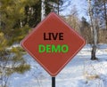 Live demo symbol. Concept words Live demo on beautiful red road sign. Beautiful forest snow blue sky background. Copy space. Royalty Free Stock Photo