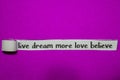 Live Dream More Love Believe, Inspiration, Motivation and business concept on purple torn paper