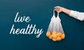 Live healthy concepts with female holding fresh orange from garden