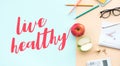 Live healthy concepts with text and red,green apple on desk worktable background