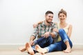 Live. Laugh. Love.an affectionate young couple sitting beside each other on the floor at home. Royalty Free Stock Photo