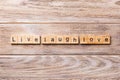 Live laugh love word written on wood block. Live laugh love text on wooden table for your desing, concept Royalty Free Stock Photo