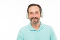 Live life loud. Mature man in stereo headphones. Happy bearded man listening to music via earphones. Elderly man