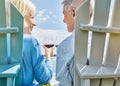 Live a life worth celebrating. a happy senior couple relaxing together outside and toasting with wine.