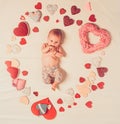 Live in love. Family. Child care. Small girl among red hearts. Sweet little baby. New life and birth. Love. Portrait of