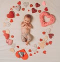 Live in love. Family. Child care. Small girl among red hearts. Sweet little baby. New life and birth. Love. Portrait of Royalty Free Stock Photo