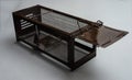 Live mouse or rat trap humane pest control  , brown cage on light background Royalty Free Stock Photo