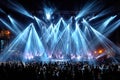 Live Music Concert with Bright Stage Lights and Large Crowd Royalty Free Stock Photo