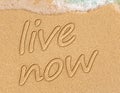 Live now, mindfulness concept, text written on the sand Royalty Free Stock Photo