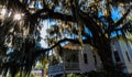 Live Oak Tree Draped With Spanish Moss and Historic Home Near Waterfront Park Royalty Free Stock Photo