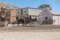 Live performance view of cowboy scenes, with 3 cowboys in wagon, on Oasys - Mini Hollywood, Spanish Western theme park, Western