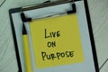 Live on Purpose write on sticky notes isolated on Wooden Table Royalty Free Stock Photo