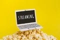 live streaming concepts with text on paper art laptop and.pop corn on pastel color