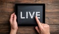 Live Streaming Word On Tablet Held In Hand On Wooden Table, Demonstrating Internet Marketing Techniques. Royalty Free Stock Photo