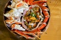 Live TARABA King Crab steamed on wooden tray. Legs and claws were cut into pieces. Taraba fried rice are in the crab shell