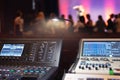 Live theater concert show sound video music control console with scene lights background. Sound engineer mixer