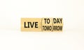Live today not tomorrow symbol. Businessman turns wooden cubes and changes word Live tomorrow to Live today. Beautiful white