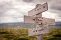 live the truth text engraved on old wooden signpost outdoors in nature