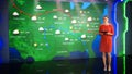 Live Weather News Studio with Professional Female On-Camera Meteorologist Standing Beside Screen a