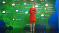 Live Weather News Studio with Professional Female On-Camera Meteorologist Standing Beside Screen a