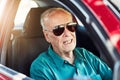 Live your life and forget your age. Cropped portrait of a senior man wearing sunglasses while driving his car. Royalty Free Stock Photo