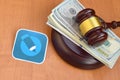 Livejournal paper logo lies with judge gavel and hundred dollar bills. Entertainment lawsuit concept