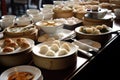 A lively, bustling dim sum experience, showcasing an array of steamed and fried dumplings, buns, and other small plates. Set in an