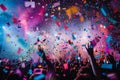 A lively crowd of people at a concert, surrounded by falling confetti and colorful streamers, A burst of confetti rains down on Royalty Free Stock Photo